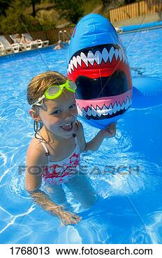 Stock Photo - girl playing in 
swimming pool 
with inflatable 
shark. fotosearch 
- search stock 
photos, pictures, 
images, and photo 
clipart