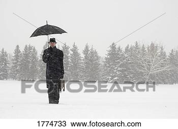 Stock Photo - businessman waiting 
in the snow. fotosearch 
- search stock 
photos, pictures, 
images, and photo 
clipart