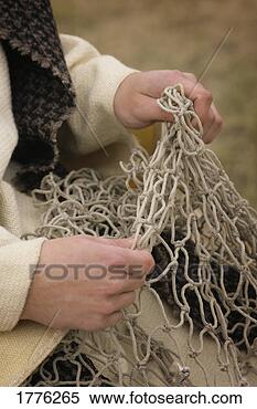 Stock Image - fisherman working 
on a net. fotosearch 
- search stock 
photos, pictures, 
images, and photo 
clipart