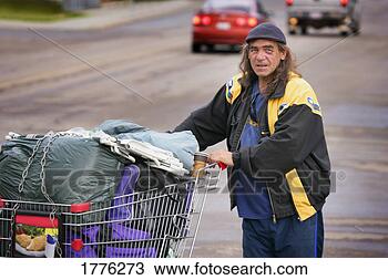 Stock Photo - homeless man with 
his belongings 
in shopping trolley. 
fotosearch - search 
stock photos, 
pictures, images, 
and photo clipart