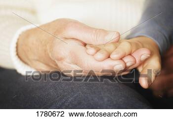 Stock Photo - inter-generational 
couple holding 
hands. fotosearch 
- search stock 
photos, pictures, 
images, and photo 
clipart