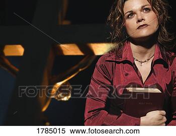 Stock Image - woman holding 
bible with jesus 
on cross in background. 
fotosearch - search 
stock photos, 
pictures, images, 
and photo clipart