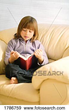 Stock Photograph - child reading 
a book. fotosearch 
- search stock 
photos, pictures, 
images, and photo 
clipart