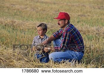 Stock Photography - farmer and son 
in field. fotosearch 
- search stock 
photos, pictures, 
images, and photo 
clipart