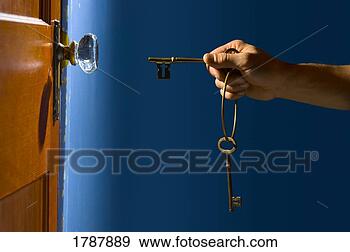 Stock Photograph - hand with keys 
about to open 
lock. fotosearch 
- search stock 
photos, pictures, 
images, and photo 
clipart