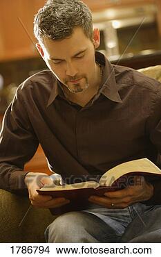 Stock Photo - man reading his 
bible. fotosearch 
- search stock 
photos, pictures, 
images, and photo 
clipart
