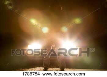 Stock Photo - standing in front 
of a car. fotosearch 
- search stock 
photos, pictures, 
images, and photo 
clipart