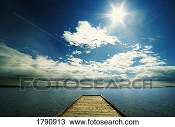 Stock Photo - bright sun over 
dock on lake. 
fotosearch - search 
stock photos, 
pictures, images, 
and photo clipart