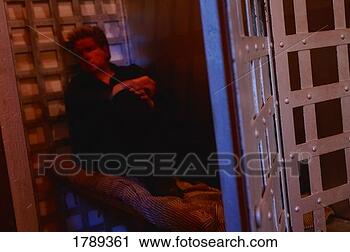 Stock Photography - man in jail cell. 
fotosearch - search 
stock photos, 
pictures, images, 
and photo clipart