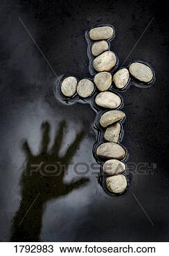 Stock Photo - hand reaching 
over water for 
cross made of 
rocks. fotosearch 
- search stock 
photos, pictures, 
images, and photo 
clipart