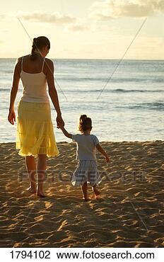 Stock Photo - mother and daughter 
at the beach. 
fotosearch - search 
stock photos, 
pictures, images, 
and photo clipart