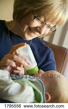 Stock Photo - grandma feeding 
grandchild. fotosearch 
- search stock 
photos, pictures, 
images, and photo 
clipart