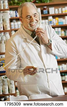 Stock Photograph - pharmacist on 
the phone. fotosearch 
- search stock 
photos, pictures, 
images, and photo 
clipart
