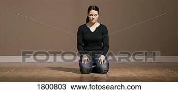 Stock Photo - woman on knees 
on the floor. 
fotosearch - search 
stock photos, 
pictures, images, 
and photo clipart