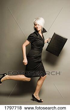Stock Photo - woman running 
while holding 
a briefcase. fotosearch 
- search stock 
photos, pictures, 
images, and photo 
clipart