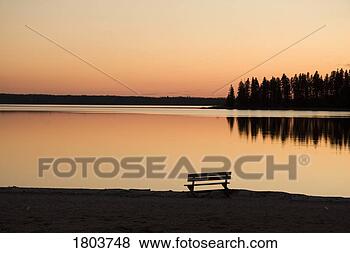Stock Photo - a bench silhouetted 
at sunset near 
the lake. fotosearch 
- search stock 
photos, pictures, 
images, and photo 
clipart
