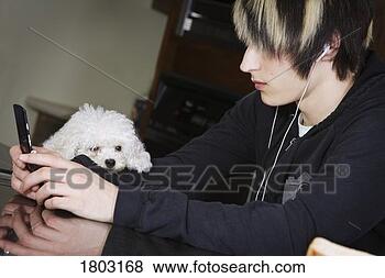 Stock Photo - a boy listening 
to music on his 
mobile phone. 
fotosearch - search 
stock photos, 
pictures, images, 
and photo clipart
