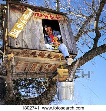 Stock Photography - boy renovating 
treehouse. fotosearch 
- search stock 
photos, pictures, 
images, and photo 
clipart