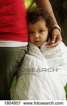 Picture - child wrapped 
up in blanket 
at mother's side. 
fotosearch - search 
stock photos, 
pictures, images, 
and photo clipart