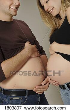 Picture - a couple comparing 
bellies. fotosearch 
- search stock 
photos, pictures, 
images, and photo 
clipart