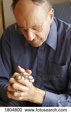 Stock Photography - elderly man praying. 
fotosearch - search 
stock photos, 
pictures, images, 
and photo clipart