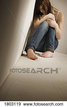 Stock Photograph - girl huddled in 
corner. fotosearch 
- search stock 
photos, pictures, 
images, and photo 
clipart