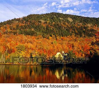 Stock Photo - house and autumn 
hillside reflected 
in the lake. fotosearch 
- search stock 
photos, pictures, 
images, and photo 
clipart