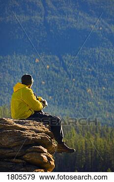 Stock Photograph - man sitting on 
a mountain in 
jasper national 
park, alberta. 
fotosearch - search 
stock photos, 
pictures, images, 
and photo clipart