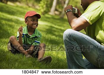 Picture - man taking a picture 
of his son. fotosearch 
- search stock 
photos, pictures, 
images, and photo 
clipart