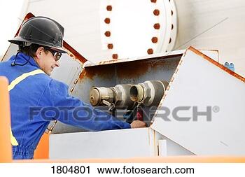 Stock Photography - man working on 
oilfield machinery. 
fotosearch - search 
stock photos, 
pictures, images, 
and photo clipart