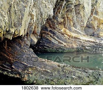 Stock Photo - rocky cave with 
water flowing 
into it. fotosearch 
- search stock 
photos, pictures, 
images, and photo 
clipart