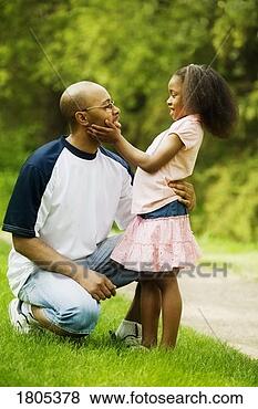 Stock Photo - side view of father 
with daughter 
in park. fotosearch 
- search stock 
photos, pictures, 
images, and photo 
clipart