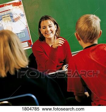 Stock Image - a teacher with 
students in a 
classroom. fotosearch 
- search stock 
photos, pictures, 
images, and photo 
clipart