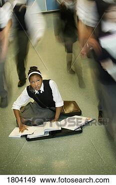 Stock Photograph - teenage girl doing 
homework in middle 
of school hall. 
fotosearch - search 
stock photos, 
pictures, images, 
and photo clipart