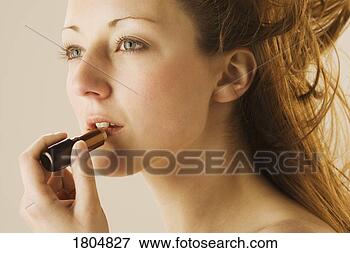 Picture - woman applying 
lipstick. fotosearch 
- search stock 
photos, pictures, 
images, and photo 
clipart