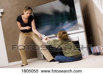 Stock Image - woman frustrated 
with boy for playing 
video game. fotosearch 
- search stock 
photos, pictures, 
images, and photo 
clipart