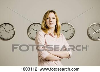 Stock Photo - woman standing 
in front of clocks. 
fotosearch - search 
stock photos, 
pictures, images, 
and photo clipart