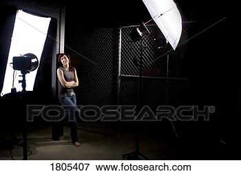 Picture - woman standing 
in the midst of 
photography equipment. 
fotosearch - search 
stock photos, 
pictures, images, 
and photo clipart