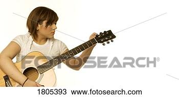 Stock Photo - woman tuning a 
guitar. fotosearch 
- search stock 
photos, pictures, 
images, and photo 
clipart
