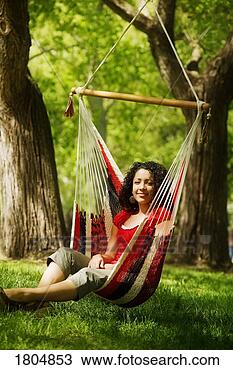 Stock Photo - young adult female 
sitting on hammock. 
fotosearch - search 
stock photos, 
pictures, images, 
and photo clipart