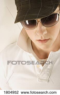 Stock Photo - young man wearing 
a hat and sunglasses. 
fotosearch - search 
stock photos, 
pictures, images, 
and photo clipart