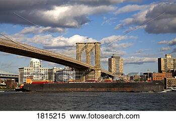 Stock Image - a barge passing 
underneath brooklyn 
bridge,  lower 
manhattan,  new. 
fotosearch - search 
stock photos, 
pictures, images, 
and photo clipart