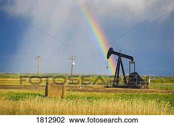 Stock Photo - storm clouds and 
rainbow over prairie 
oil pump. fotosearch 
- search stock 
photos, pictures, 
images, and photo 
clipart