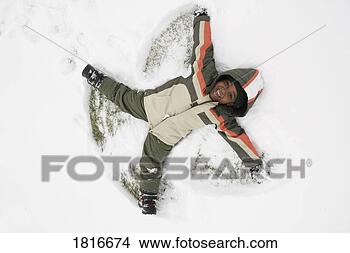 Stock Photo - high angle view 
of a boy lying 
on snow. fotosearch 
- search stock 
photos, pictures, 
images, and photo 
clipart