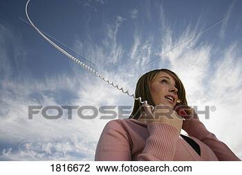 Stock Photo - low angle view 
of woman talking 
on phone. fotosearch 
- search stock 
photos, pictures, 
images, and photo 
clipart