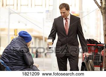 Stock Photograph - businessman giving 
coffee to homeless 
man. fotosearch 
- search stock 
photos, pictures, 
images, and photo 
clipart