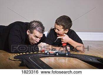 Stock Photo - father and son 
playing with race 
track. fotosearch 
- search stock 
photos, pictures, 
images, and photo 
clipart