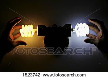 Stock Photo - hands near energy 
efficient light 
bulbs. fotosearch 
- search stock 
photos, pictures, 
images, and photo 
clipart