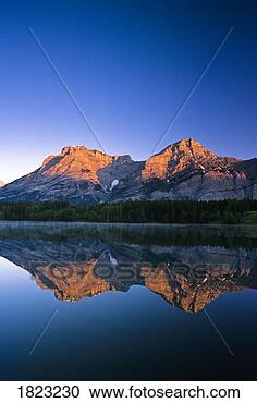 Stock Photography - mount kidd reflected 
in wedge pond, 
 kananaskis country, 
 alberta. fotosearch 
- search stock 
photos, pictures, 
images, and photo 
clipart