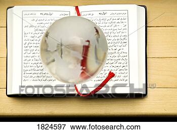 Picture - new testament 
of the bible written 
in arabic with 
a globe magnifying. 
fotosearch - search 
stock photos, 
pictures, images, 
and photo clipart
